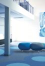 2000 PUR homogeneous vinyl flooring with circular inlay detail in a blue breakout seating area