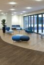 Forest fx PUR heterogeneous vinyl flooring in a pale oak plank design in an office breakout area