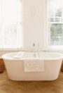 Secura PUR loose lay vinyl flooring in a pale wood design in a bathroom interior